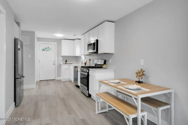 a kitchen with a stove a sink and a refrigerator