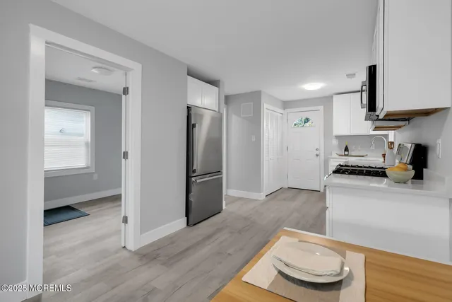 a kitchen with stainless steel appliances a refrigerator and a stove