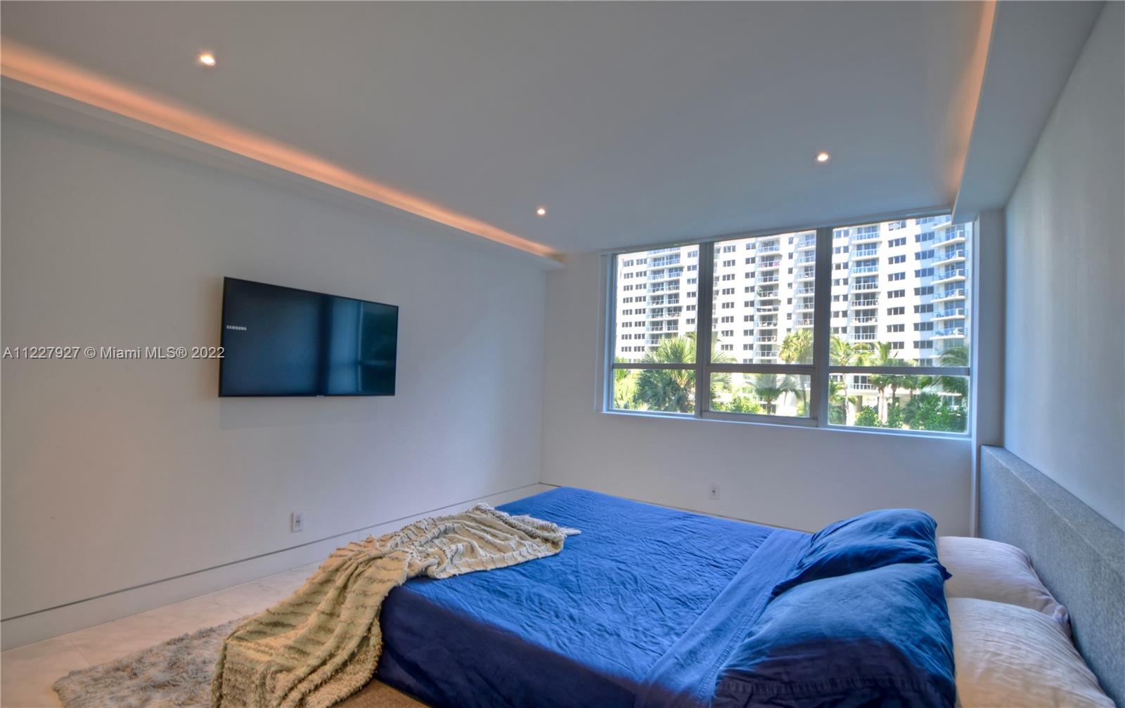 1500 Bay Road, Unit 364S Miami Beach, FL 33139 - Photo 14 of 28 a bed sitting in a bedroom next to a window