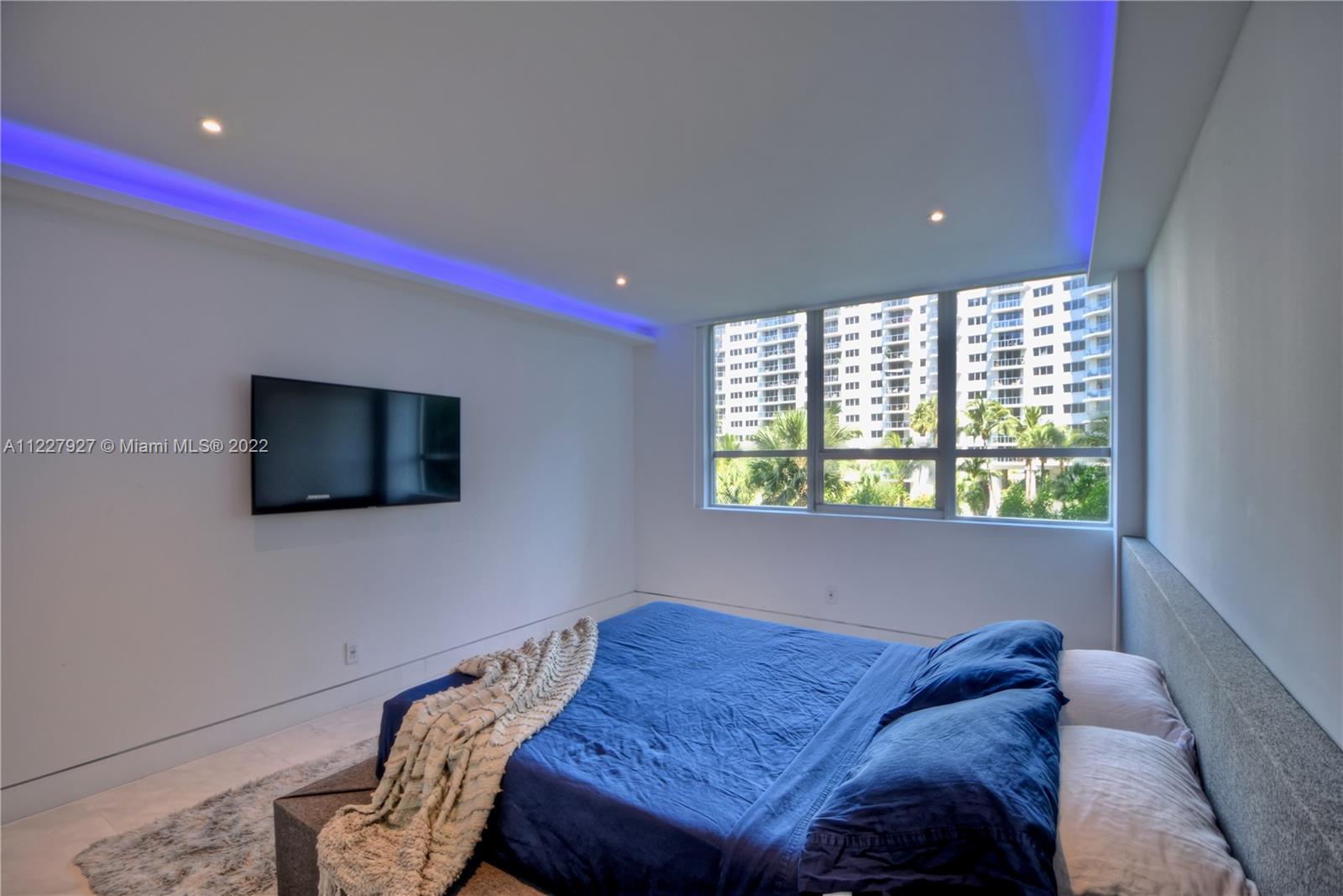 1500 Bay Road, Unit 364S Miami Beach, FL 33139 - Photo 15 of 28 a bed sitting in a bedroom next to a window