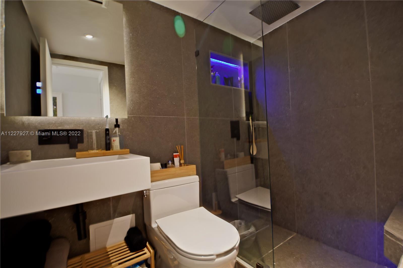 1500 Bay Road, Unit 364S Miami Beach, FL 33139 - Photo 18 of 28 a white toilet sitting next to a bathroom sink