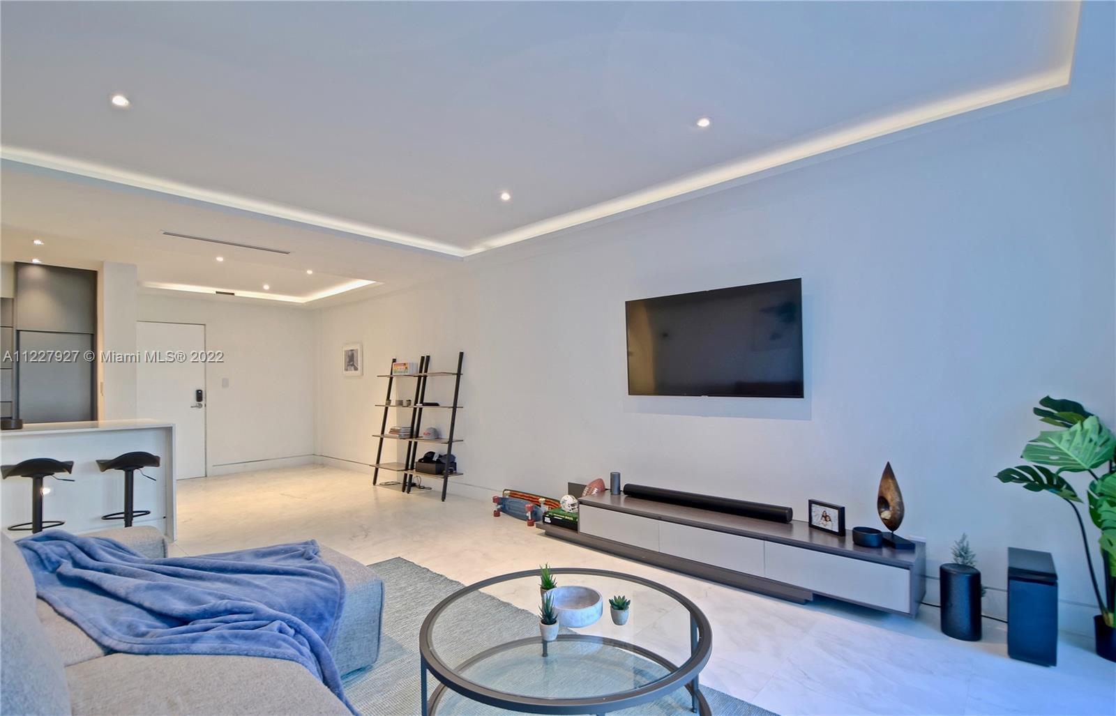 1500 Bay Road, Unit 364S Miami Beach, FL 33139 - Photo 2 of 28 a living room with furniture and a flat screen tv