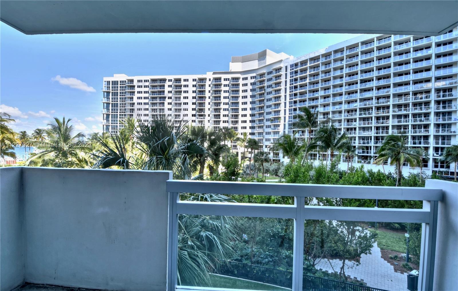 1500 Bay Road, Unit 364S Miami Beach, FL 33139 - Photo 23 of 28 a view of a balcony with a couple of cars parked in front of it