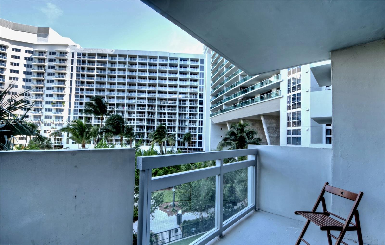 1500 Bay Road, Unit 364S Miami Beach, FL 33139 - Photo 24 of 28 a front view of a building with a yard