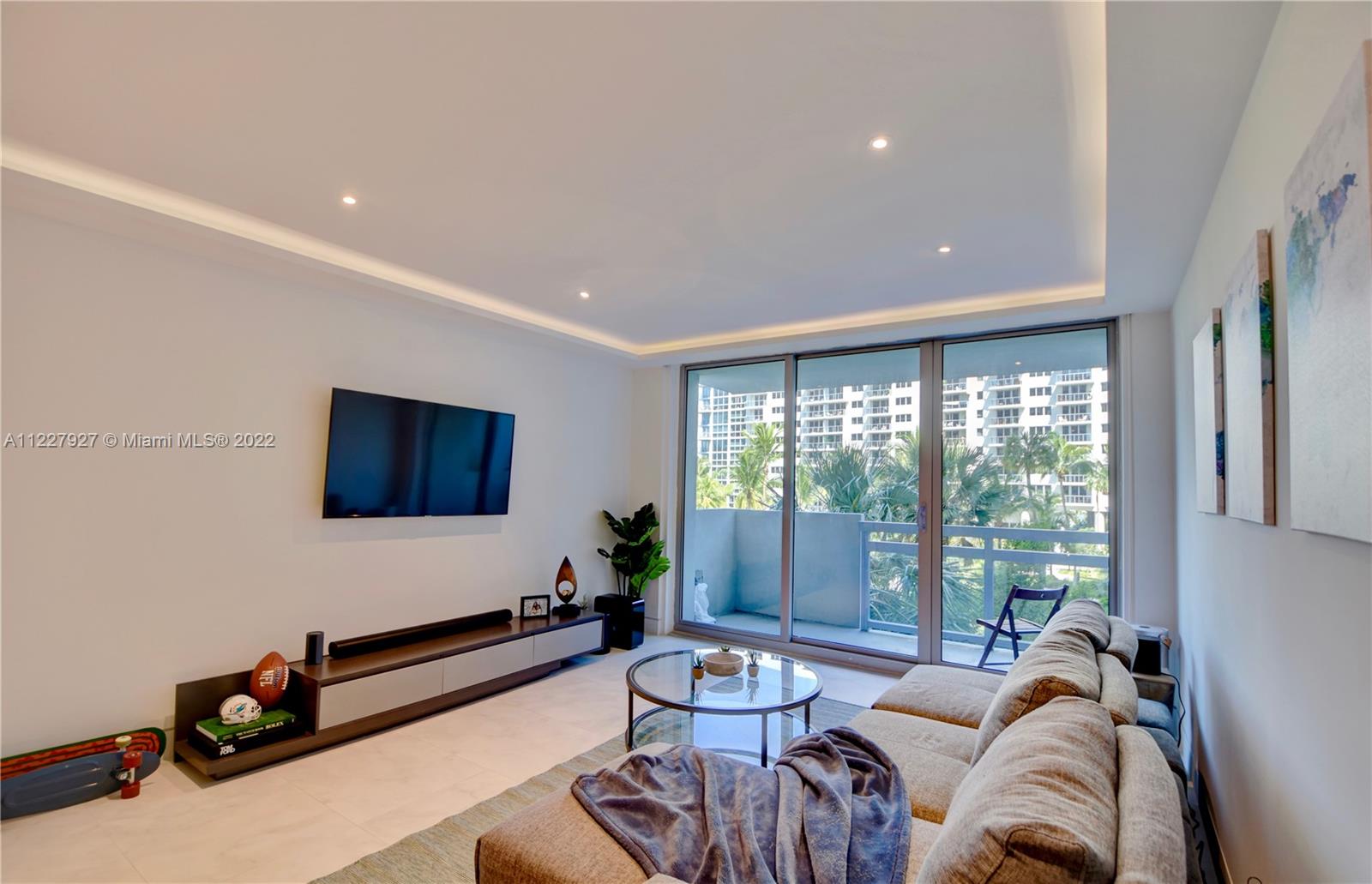 1500 Bay Road, Unit 364S Miami Beach, FL 33139 - Photo 4 of 28 a living room with furniture flat screen tv and a large window