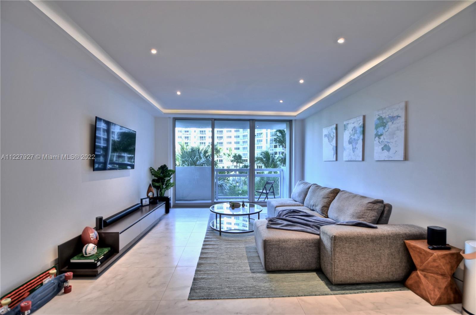 1500 Bay Road, Unit 364S Miami Beach, FL 33139 - Photo 6 of 28 a living room with furniture and a floor to ceiling window