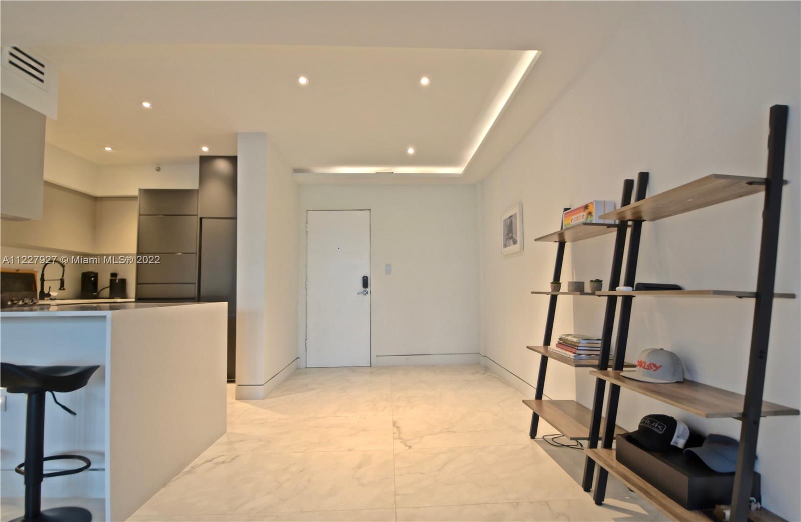 1500 Bay Road, Unit 364S Miami Beach, FL 33139 - Photo 7 of 28 a view of kitchen with refrigerator and wooden floor
