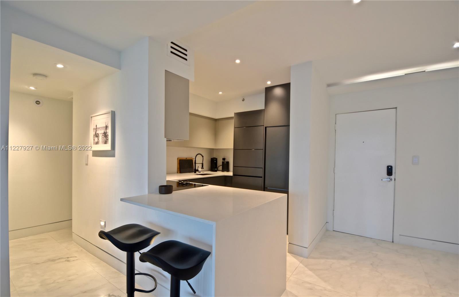 1500 Bay Road, Unit 364S Miami Beach, FL 33139 - Photo 8 of 28 a kitchen with stainless steel appliances a refrigerator and a stove top oven