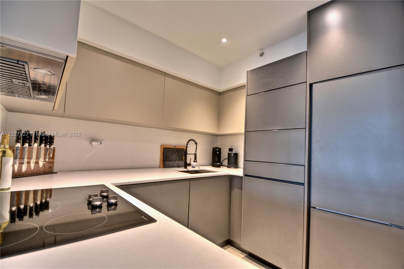 1500 Bay Road, Unit 364S Miami Beach, FL 33139 - Photo 9 of 28 a kitchen with stainless steel appliances a refrigerator and a sink
