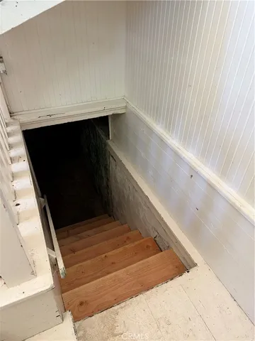 an empty room with ceiling fan and window