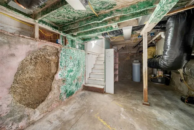 a kitchen with a refrigerator sink and cabinets