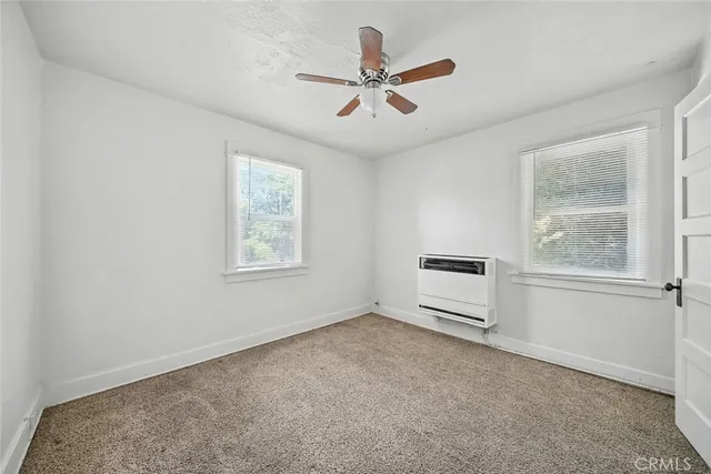 a big room with wooden floor and windows