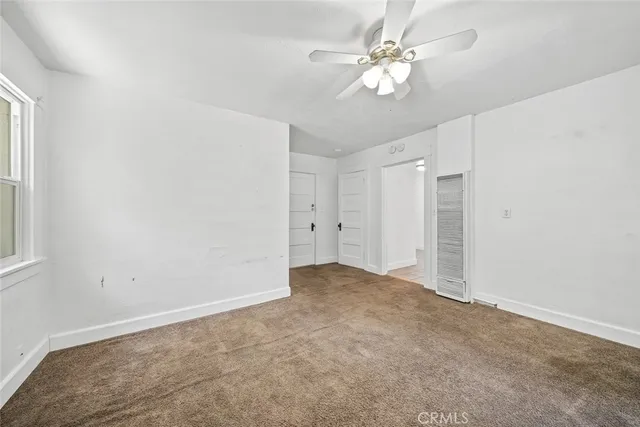 a view of a backyard with a trees and wooden fence