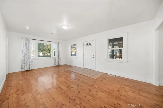 a view of an empty room and wooden floor