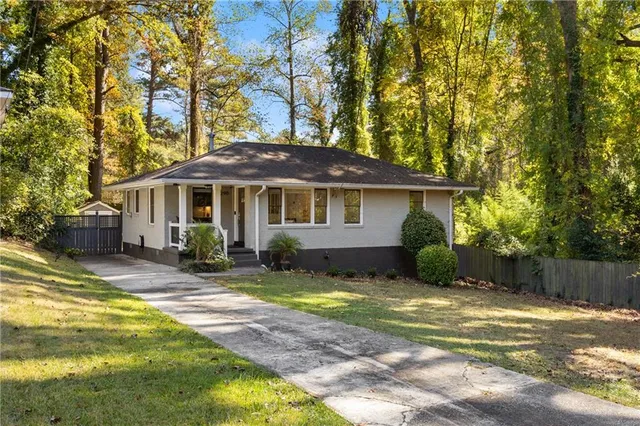 a view of a chair and table in backyard of the house