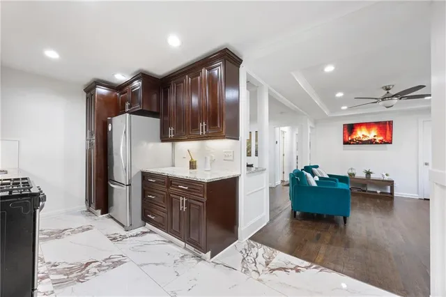 a kitchen with stainless steel appliances granite countertop a stove and a microwave