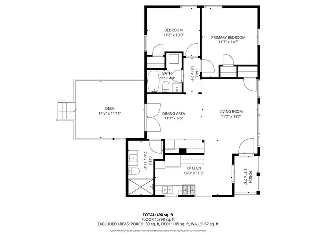 a view of a lake with a bench and trees in the background