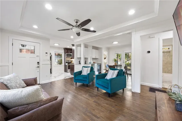 a living room with furniture and wooden floor