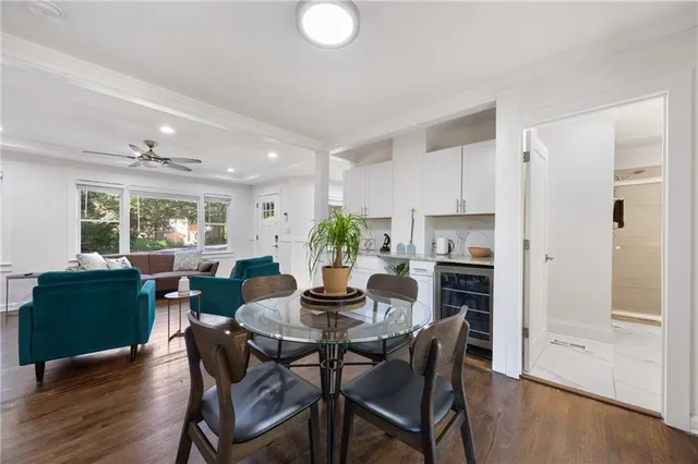 a bathroom with a toilet a sink a mirror and shower