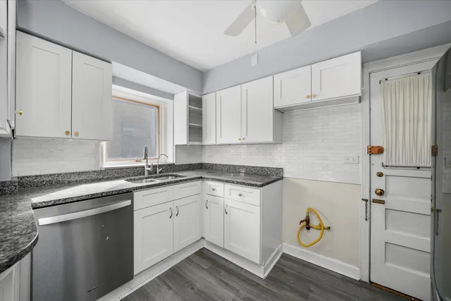 a kitchen with a sink and a stove top oven