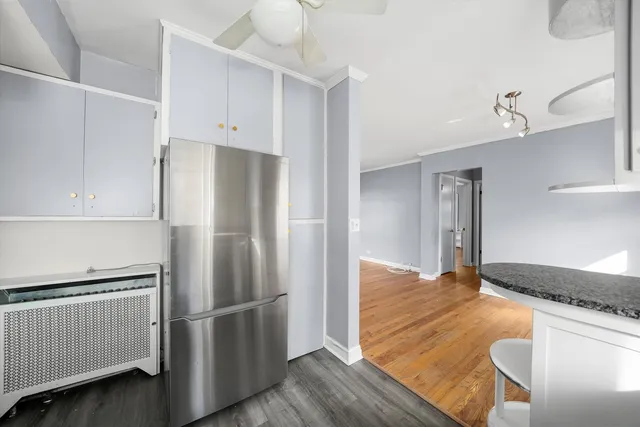 a kitchen with granite countertop white cabinets and stainless steel appliances