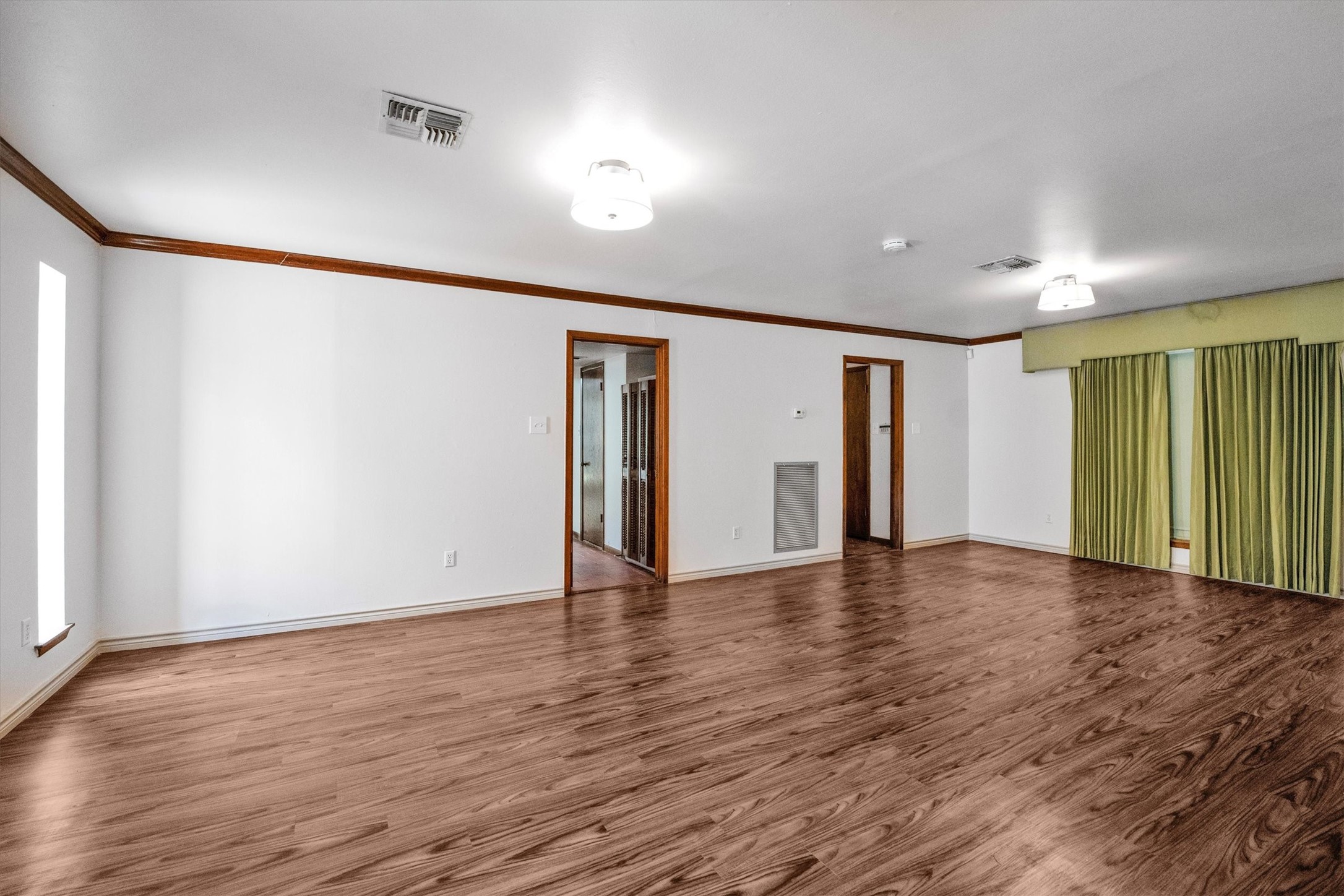 1417 15th Street Huntsville, TX 77340 - Photo 11 of 45 a view of an empty room with wooden floor