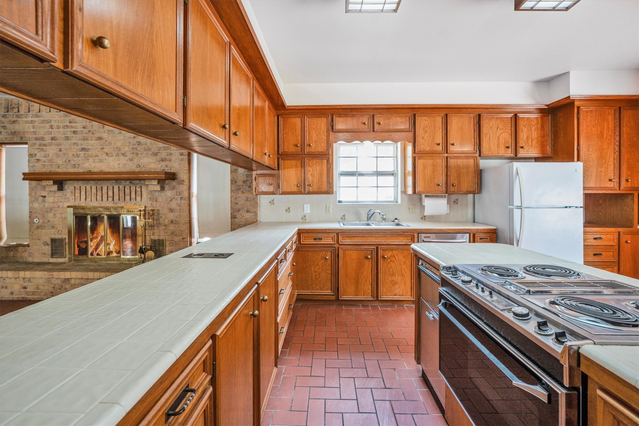 1417 15th Street Huntsville, TX 77340 - Photo 19 of 45 a kitchen with a stove a sink and a refrigerator