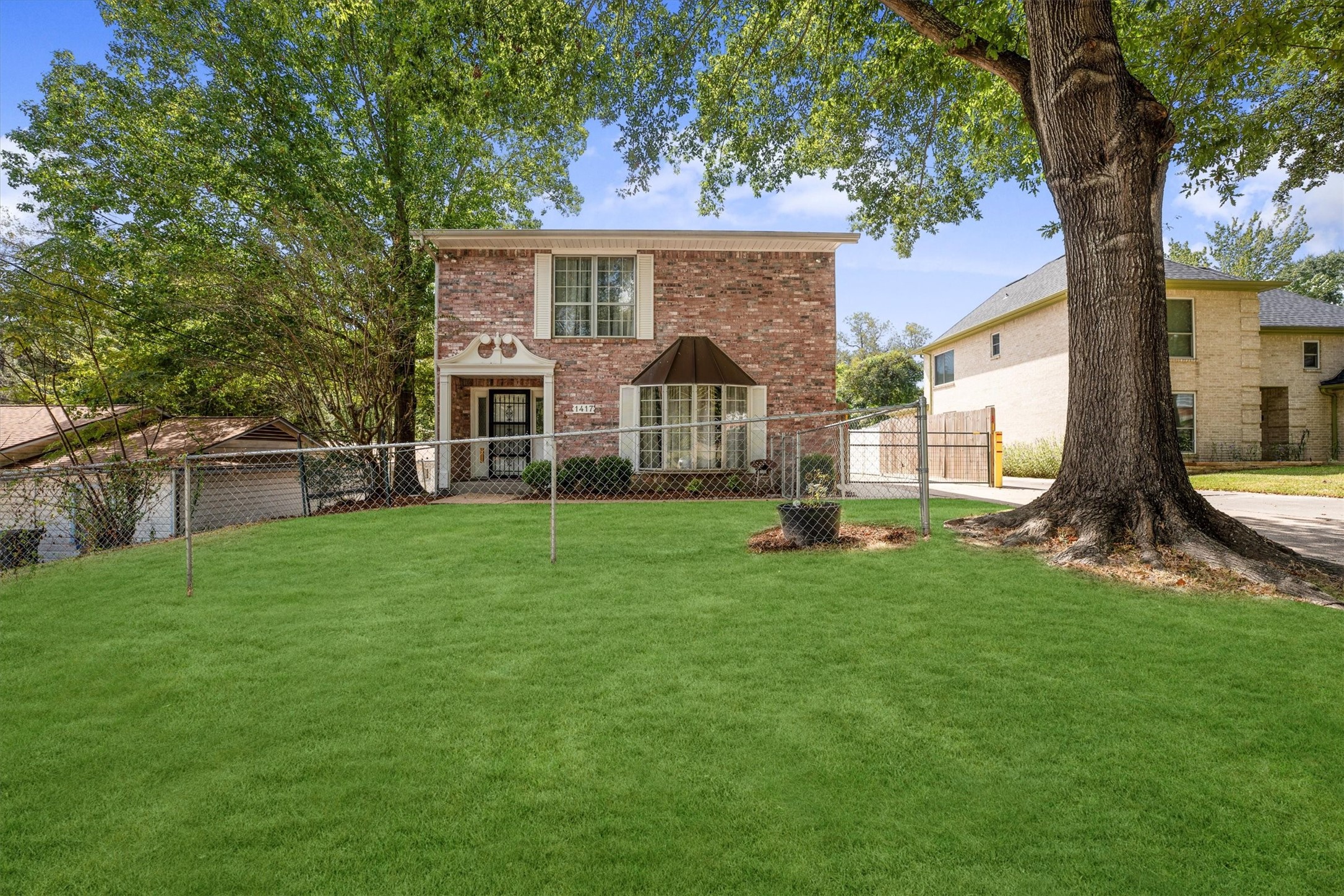 1417 15th Street Huntsville, TX 77340 - Photo 2 of 45 a view of a house with backyard and a tree