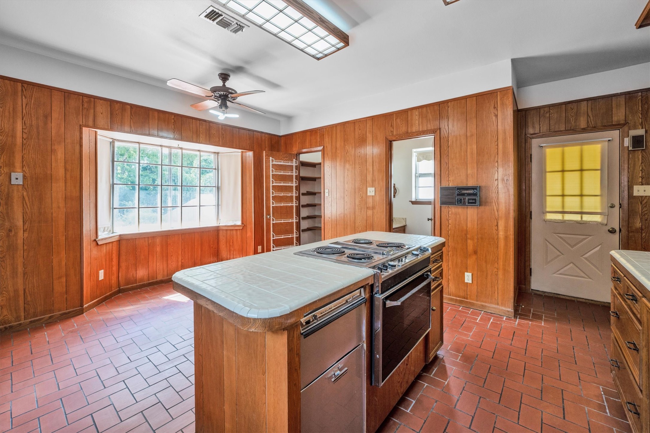 1417 15th Street Huntsville, TX 77340 - Photo 22 of 45 a kitchen that has a stove a sink and a wooden floor