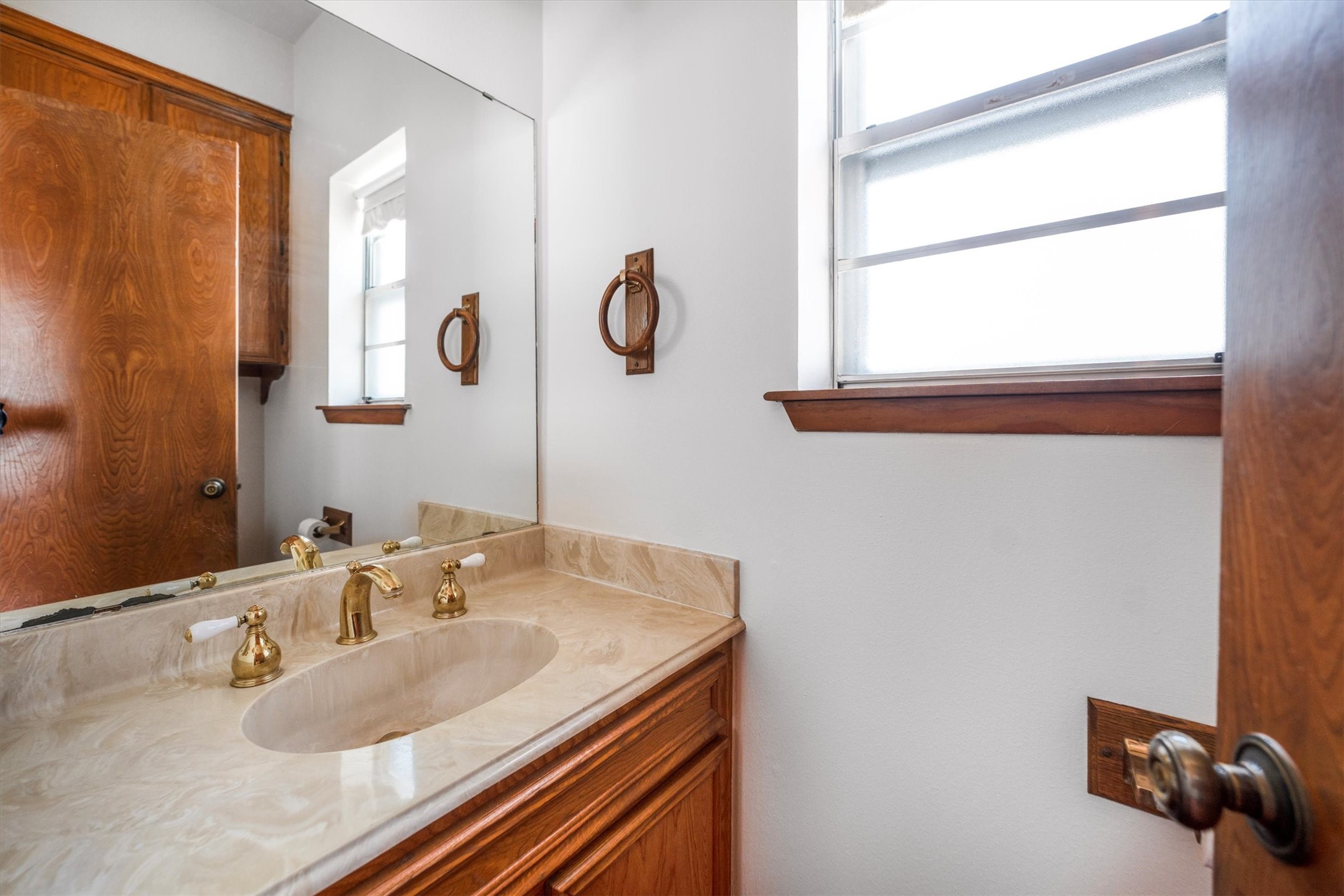 1417 15th Street Huntsville, TX 77340 - Photo 26 of 45 a bathroom with a granite countertop sink and a mirror
