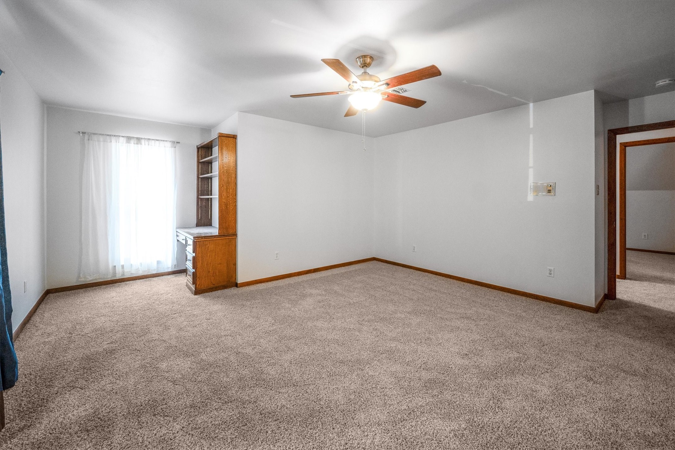 1417 15th Street Huntsville, TX 77340 - Photo 28 of 45 an empty room with windows and fan