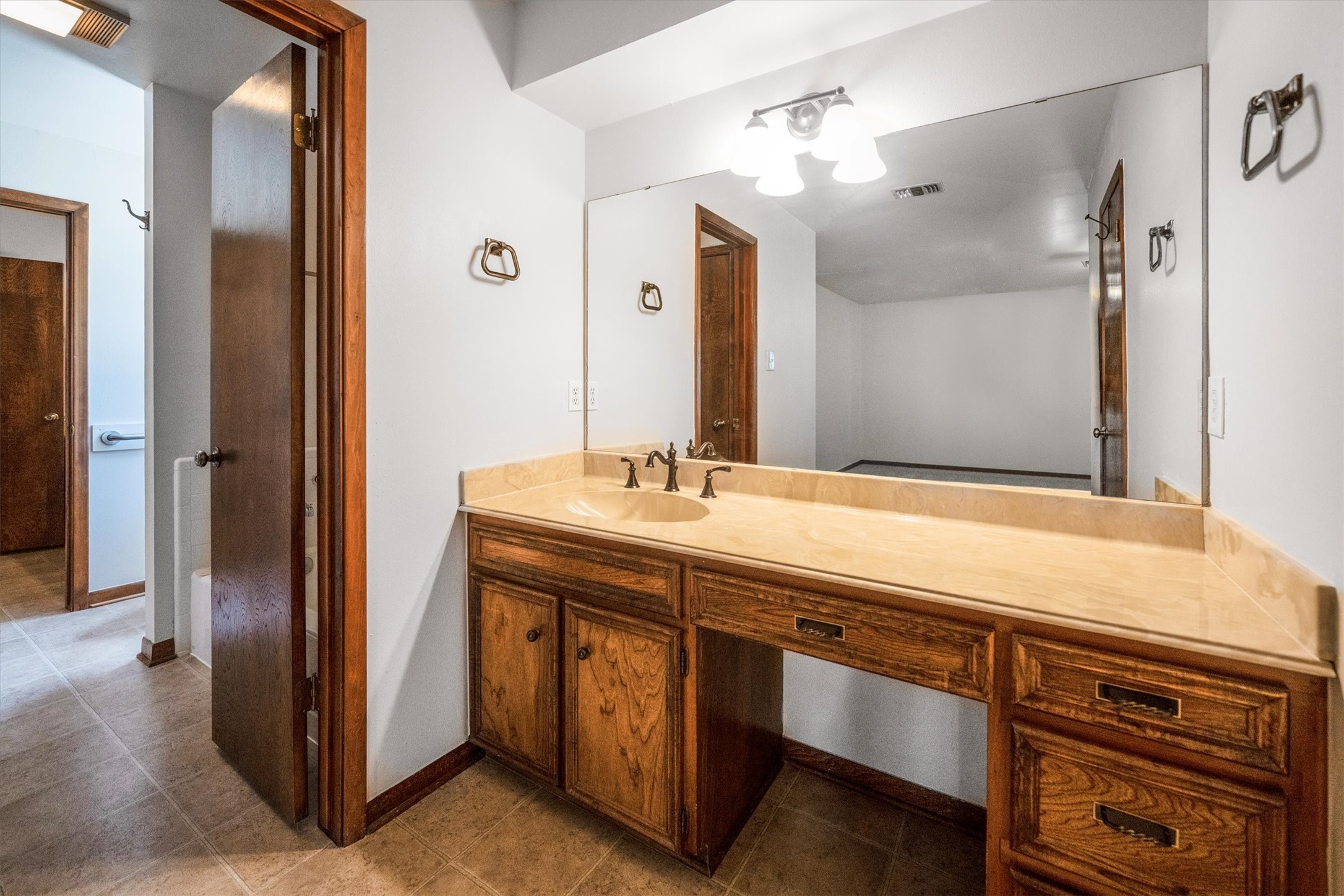 1417 15th Street Huntsville, TX 77340 - Photo 30 of 45 a bathroom with a sink and a mirror