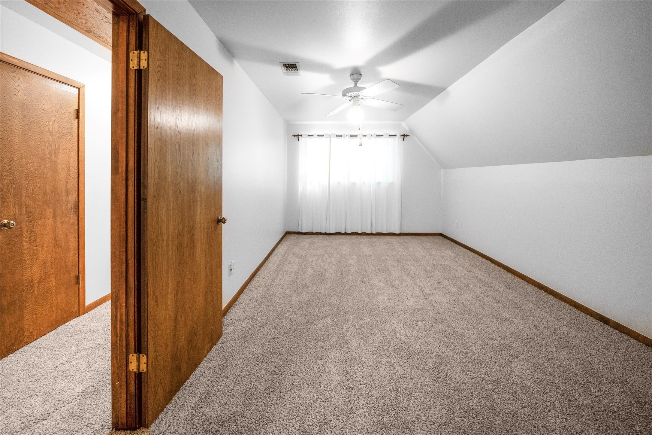 1417 15th Street Huntsville, TX 77340 - Photo 33 of 45 an empty room with windows and fan