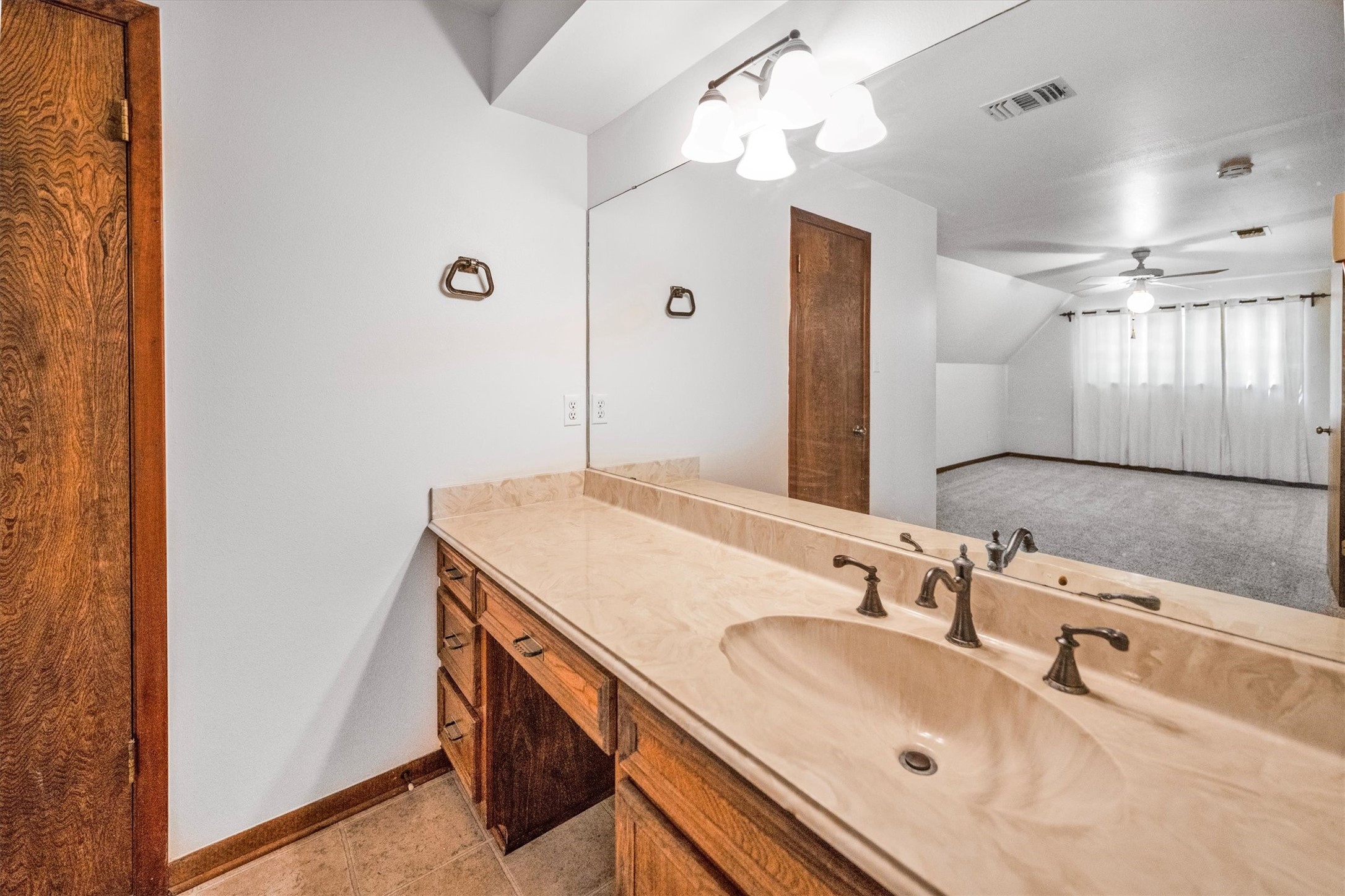 1417 15th Street Huntsville, TX 77340 - Photo 36 of 45 a bathroom with a sink and a mirror