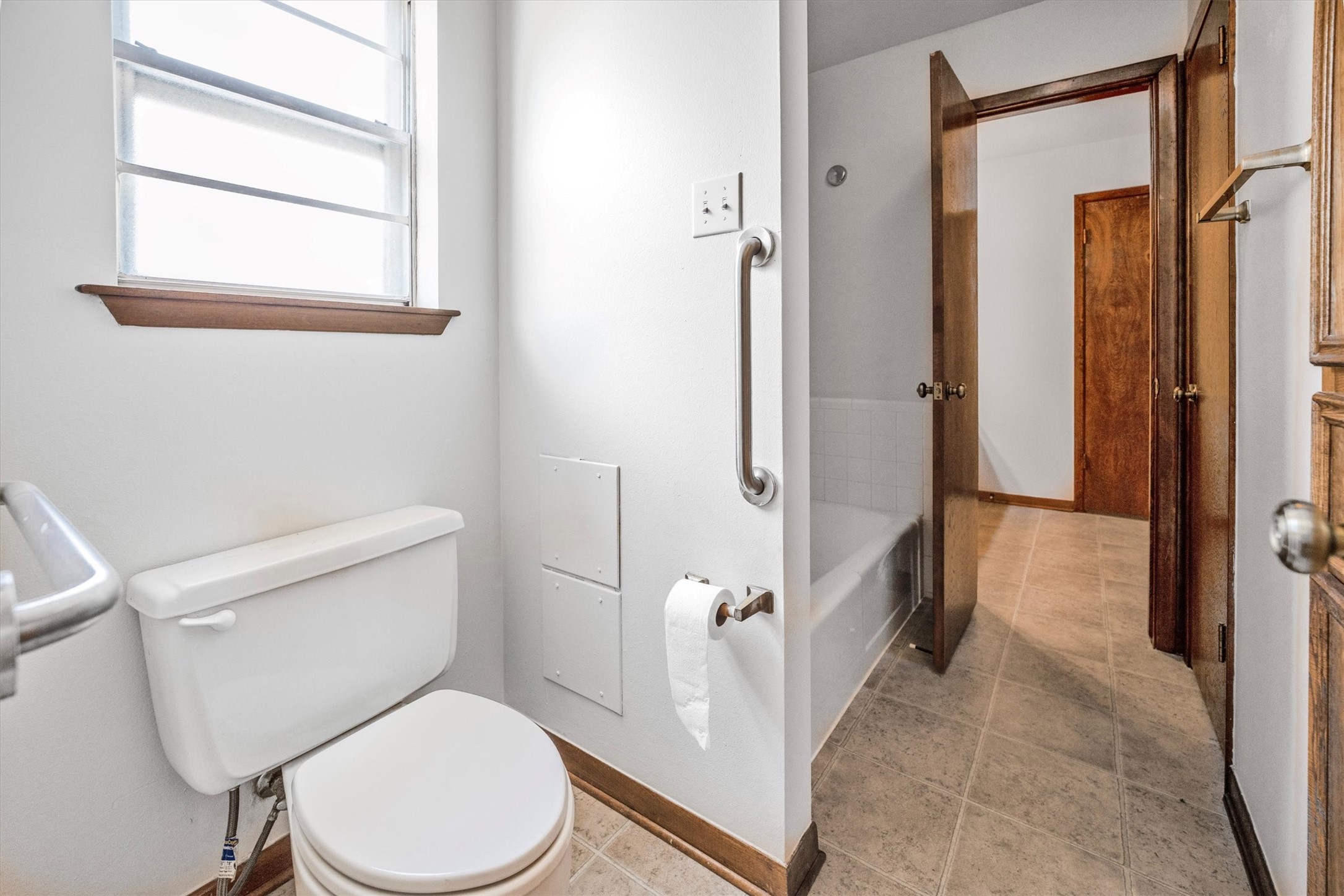 1417 15th Street Huntsville, TX 77340 - Photo 38 of 45 a white toilet sitting next to a bathroom sink