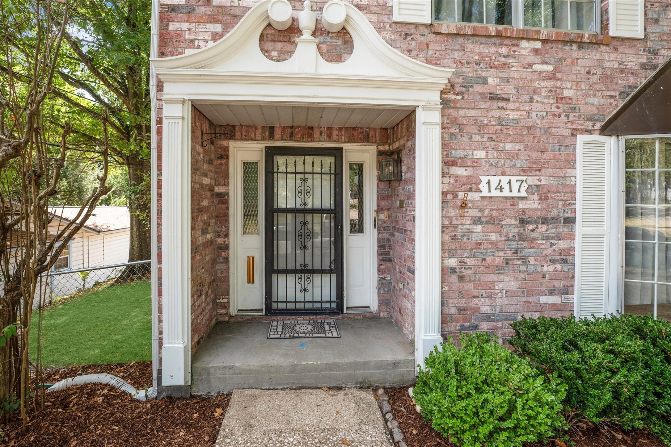 1417 15th Street Huntsville, TX 77340 - Photo 4 of 45 a view of a brick house with a large window