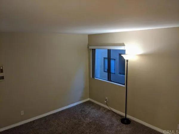 an empty room with closet area