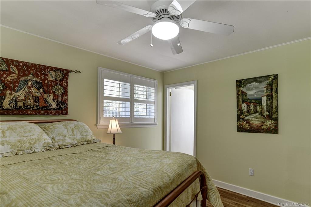 215 Rutledge Drive Hendersonville, NC 28739 - Photo 13 of 31 a bedroom with a large bed and a window