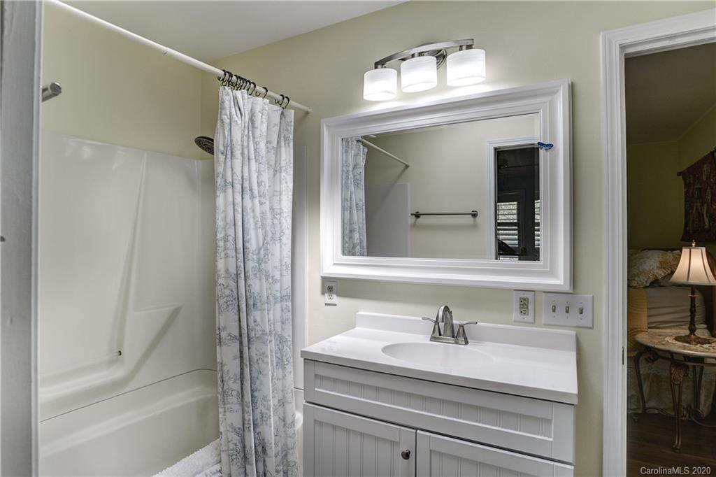 215 Rutledge Drive Hendersonville, NC 28739 - Photo 14 of 31 a bathroom with a sink and a mirror