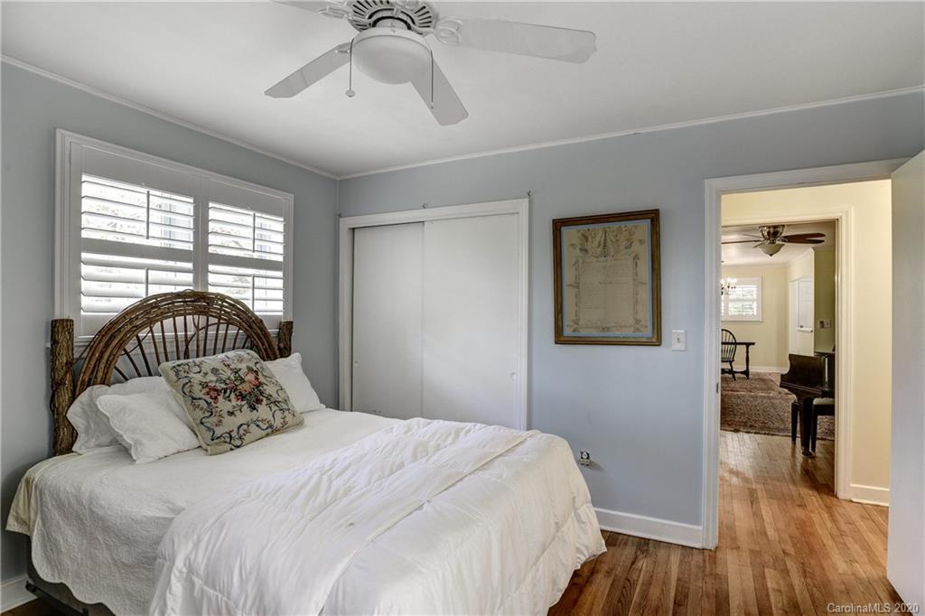 215 Rutledge Drive Hendersonville, NC 28739 - Photo 15 of 31 a bedroom with a bed and wooden floor