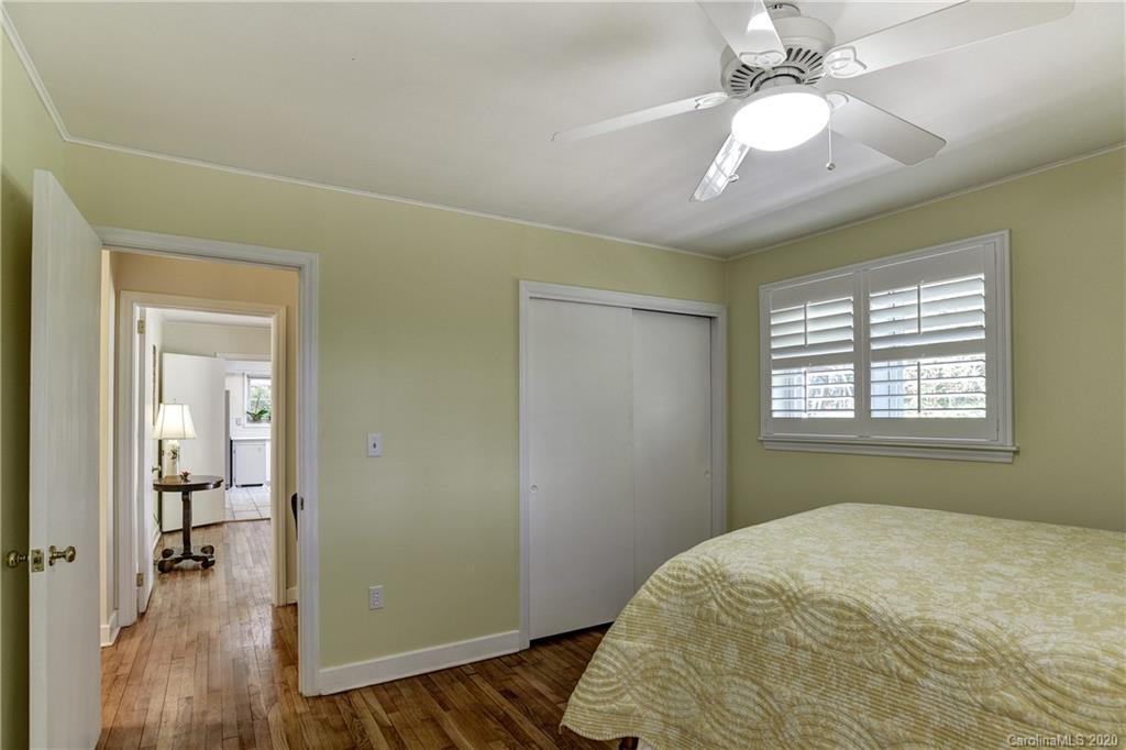 215 Rutledge Drive Hendersonville, NC 28739 - Photo 26 of 31 a bedroom with a bed and a chandelier