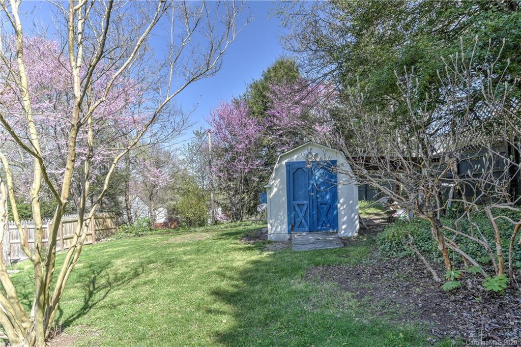 215 Rutledge Drive Hendersonville, NC 28739 - Photo 28 of 31 a view of backyard with wooden fence and large trees