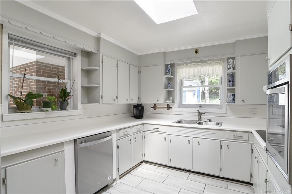 215 Rutledge Drive Hendersonville, NC 28739 - Photo 6 of 31 a kitchen with a sink window and cabinets