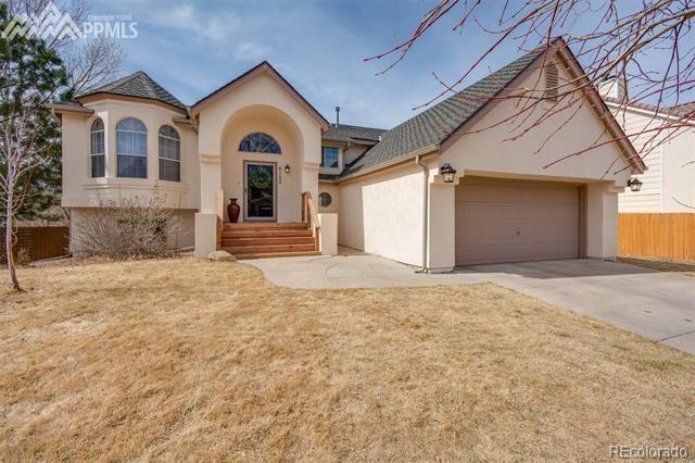 6150 Rabbit Ears Court Colorado Springs, CO 80919 - Photo 1 of 31 a view of a house with a yard