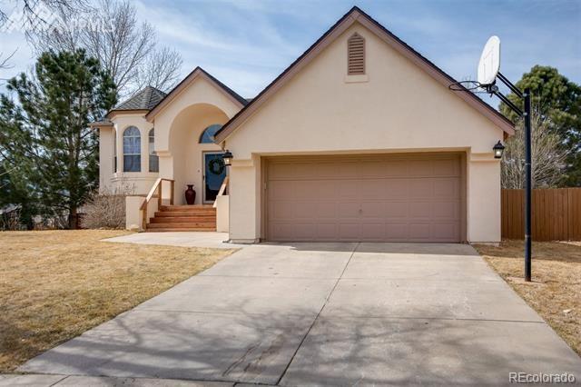 6150 Rabbit Ears Court Colorado Springs, CO 80919 - Photo 2 of 31 a front view of a house with a yard and garage