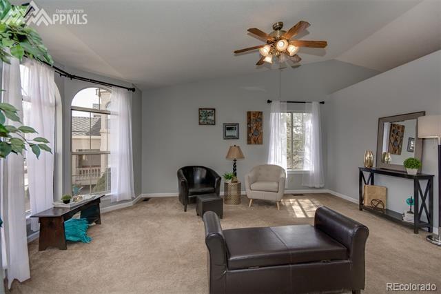 6150 Rabbit Ears Court Colorado Springs, CO 80919 - Photo 4 of 31 a living room with furniture and a large window
