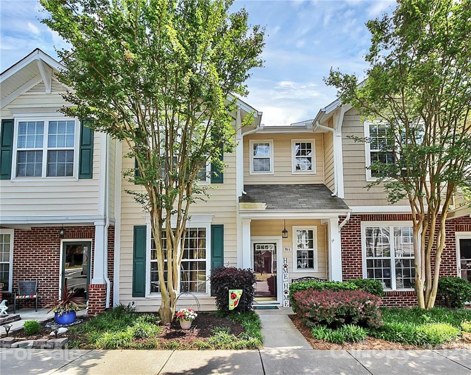 911 Azurine Circle, Unit 74 Fort Mill, SC 29708 - Photo 1 of 40 a front view of a house with a yard and table and chairs