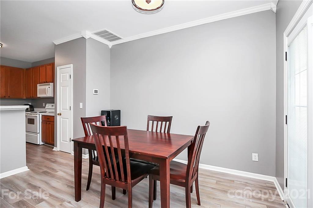 911 Azurine Circle, Unit 74 Fort Mill, SC 29708 - Photo 17 of 40 a view of a dining room with furniture and wooden floor