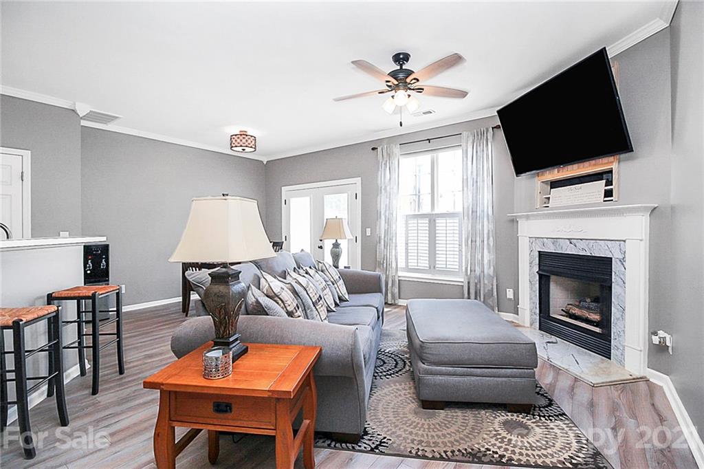 911 Azurine Circle, Unit 74 Fort Mill, SC 29708 - Photo 22 of 40 a living room with furniture a fireplace and a flat screen tv