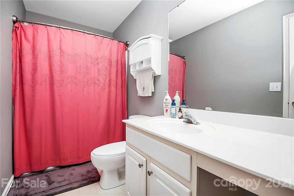 911 Azurine Circle, Unit 74 Fort Mill, SC 29708 - Photo 27 of 40 a bathroom with a sink a toilet and shower curtain